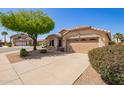 Inviting single-story home with a two-car garage and desert-style landscaping, showcasing a well-maintained exterior at 44454 W Oster Dr, Maricopa, AZ 85138