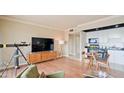 Well-lit living room offering a TV, access to kitchen area, and a telescope for city viewing at 4750 N Central Ave # D15, Phoenix, AZ 85012