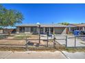 Modest single-story home with desert landscaping and a chain link fence needs some TLC at 4870 W Almeria Rd, Phoenix, AZ 85035