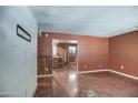 Spacious living room with hardwood floors and connected to the kitchen in need of renovation at 4870 W Almeria Rd, Phoenix, AZ 85035