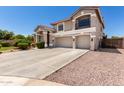 Charming two-story home with a three-car garage and low-maintenance landscaping at 5322 N Oro Vista Ct, Litchfield Park, AZ 85340