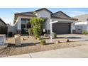 Attractive front yard with desert landscaping, complemented by a well-maintained home exterior at 7812 W Payson Rd, Phoenix, AZ 85043