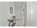 Inviting hallway with neutral tile flooring, leading to various rooms in the home at 7812 W Payson Rd, Phoenix, AZ 85043