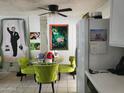 Bright dining area with a glass-top table, lime green chairs and unique artistic decor on the wall at 815 N Hayden Rd # B4, Scottsdale, AZ 85257