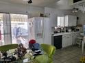 Functional kitchen with white cabinets, modern appliances, a view to the back patio and a cozy breakfast area at 815 N Hayden Rd # B4, Scottsdale, AZ 85257