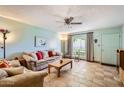 Inviting living room with tile flooring, neutral walls, ceiling fan, and comfortable furnishings at 8241 N Central Ave # 2, Phoenix, AZ 85020