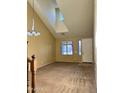 Open living room features neutral carpet, tall ceilings and bright lighting at 11867 W Alvarado Rd, Avondale, AZ 85392