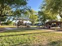 Outdoor playground and picnic area with shade for outdoor entertaining in the community at 11867 W Alvarado Rd, Avondale, AZ 85392