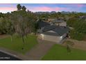 Aerial view of a home with a lush green lawn, mountain views, and a two-car garage at 13411 N 50Th St, Scottsdale, AZ 85254