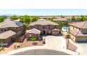 Aerial view of a two-story home with tile roof, desert landscaping, and close proximity to neighboring homes at 15725 W Yucatan Dr, Surprise, AZ 85379