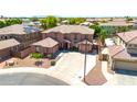 Aerial view of a well-maintained two-story home featuring a tile roof and manicured desert landscape at 15725 W Yucatan Dr, Surprise, AZ 85379