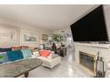 Bright living room features a fireplace, tile flooring, and large windows at 1618 N 32Nd St # 5, Phoenix, AZ 85008