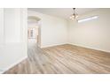Bright dining room featuring wood-look floors and decorative lighting fixture at 16515 N 71St Dr, Peoria, AZ 85382