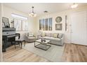Stylish living room with modern decor, wood-look floors, and natural light at 16515 N 71St Dr, Peoria, AZ 85382