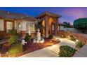 A beautiful entryway with a water fountain, manicured bushes, and a brick archway at 1934 E Cypress Tree Dr, Gilbert, AZ 85234