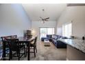Spacious living room with neutral carpet, dining area, vaulted ceilings and a sliding glass door for ample light at 205 N 74Th St # 201, Mesa, AZ 85207