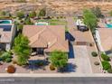 Aerial view of the home showcasing the backyard, desert landscaping, pool, and nearby homes at 226 W Crimson Sky Ct, Casa Grande, AZ 85122
