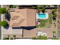 Aerial view of a house featuring a large backyard with a sparkling pool, patio furniture, and desert landscaping at 226 W Crimson Sky Ct, Casa Grande, AZ 85122