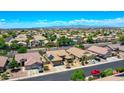 Expansive aerial view of a desert community with tile-roofed homes and mountain backdrop at 230 S 122Nd Ln, Avondale, AZ 85323