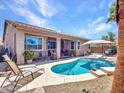 Beautiful backyard with a pool, lounge chairs, and a covered patio, great for enjoying sunny days and outdoor living at 230 S 122Nd Ln, Avondale, AZ 85323