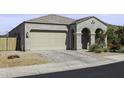 Charming single-story home with a two-car garage, arched entryway, and desert landscaping at 2354 E Lieber Pl, Phoenix, AZ 85024