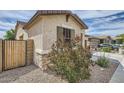 Picture of a beige home with dark green shutters and desert landscaping in the front at 266 N Piedra Way, Mesa, AZ 85207