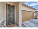 Home featuring a decorative security screen door and a two car garage to the right at 266 N Piedra Way, Mesa, AZ 85207