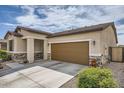 Beige home featuring an attached two car garage and a stone veneer detail near the entry at 266 N Piedra Way, Mesa, AZ 85207