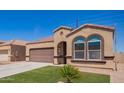 Close view of a single-Gathering home, featuring desert landscaping and a large front-facing window at 29109 N Fire Agate Rd, San Tan Valley, AZ 85143