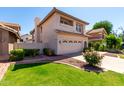 View of a two-story home, showing landscaping, a tiled roof and an attached two-car garage at 3165 W Golden Ln, Chandler, AZ 85226