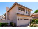 View of a two-story home, showing landscaping, a tiled roof and an attached two-car garage at 3165 W Golden Ln, Chandler, AZ 85226
