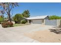 Attractive single-story home with a brick facade, a large driveway, and mature landscaping at 3736 W Angela Dr, Glendale, AZ 85308
