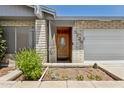 Welcoming front entrance with a decorative wooden door and a brick facade at 3736 W Angela Dr, Glendale, AZ 85308