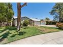 Charming single-story home featuring a well-manicured lawn and mature trees on a sunny day at 3736 W Angela Dr, Glendale, AZ 85308