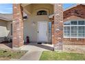 Close-up of the home's brick entryway with a white front door and stylish address plaque at 4030 E Meadow Creek Way, San Tan Valley, AZ 85140