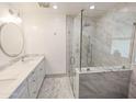 Modern bathroom featuring a glass-enclosed shower and sleek marble vanity at 4202 E Sahuaro Dr, Phoenix, AZ 85028
