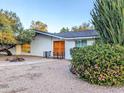Inviting single-story home with a beautifully landscaped front yard and double door entry at 4202 E Sahuaro Dr, Phoenix, AZ 85028