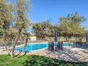 Refreshing backyard pool with a safety fence, patio furniture and lush greenery at 4202 E Sahuaro Dr, Phoenix, AZ 85028