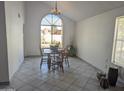 Bright dining room with a large window providing natural light and a wooden table with chairs at 4636 E Carmen St, Phoenix, AZ 85044