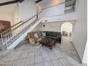 Inviting living room showcasing an open staircase, tile floors, and comfortable seating at 4636 E Carmen St, Phoenix, AZ 85044