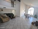 Spacious living room featuring high ceilings, tile flooring, and a large arched window for natural light at 4636 E Carmen St, Phoenix, AZ 85044