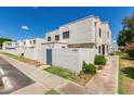 Inviting townhome showcasing white stucco exterior, private yard, and well-maintained landscaping at 5201 N 42Nd N Pkwy, Phoenix, AZ 85019