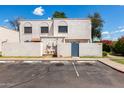 Charming white stucco townhome featuring private parking and a landscaped yard at 5201 N 42Nd N Pkwy, Phoenix, AZ 85019
