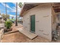 Exterior view showcasing a shed with green door surrounded by a mix of gravel and greenery at 524 W Fairway Dr # 9, Mesa, AZ 85201