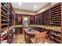 Spacious wine cellar with extensive custom wood shelving and a tasting table at 5512 E Barwick Dr, Cave Creek, AZ 85331