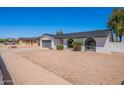 A single-story home features a well-kept front yard and an attached two-car garage at 5534 W Calavar Rd, Glendale, AZ 85306