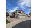 Charming two-story home with stucco exterior, red tile roof, and well-manicured desert landscaping at 5952 W Morning Dove Dr, Glendale, AZ 85308
