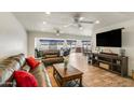 Spacious living room features wood-look floors, recessed lighting, ceiling fans, and comfortable seating at 6 E Piping Rock Rd, Phoenix, AZ 85022