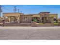 Charming home featuring beautiful stonework, a gated yard, and a covered parking area at 6459 W Columbus Ave, Phoenix, AZ 85033