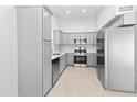 Bright kitchen featuring stainless steel appliances, light gray cabinetry, and neutral tile flooring at 6908 W Sierra St, Peoria, AZ 85345